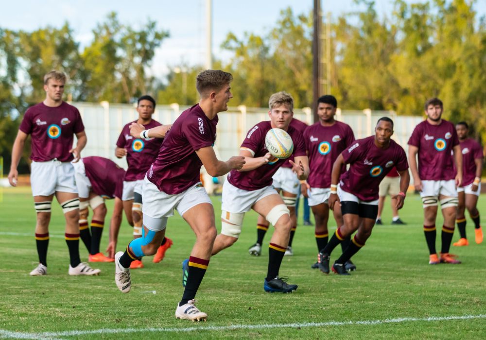 A group of young men playing rugby on a field at Stellenbosch University in South Africa.