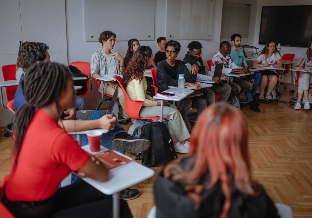 Students in a classroom at the University of Pecs, Hungary, engaged in discussion.
